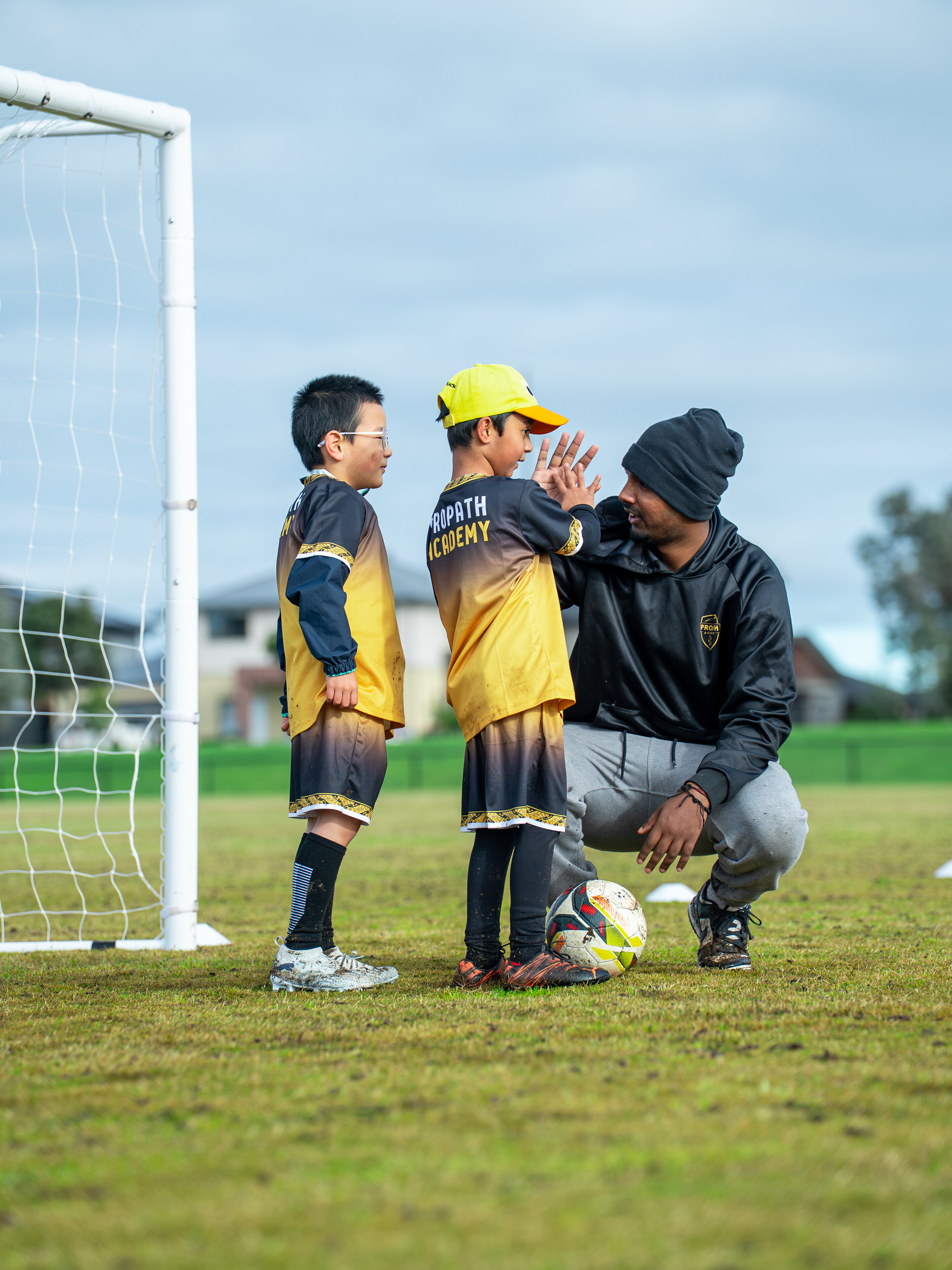 ProPath Academy coach encouraging young players beside the goal